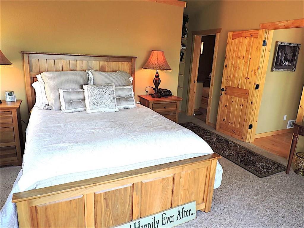 299 Gadwall Road Como, CO 80432 - Photo 13 of 25 a bed sitting in a bedroom next to a window