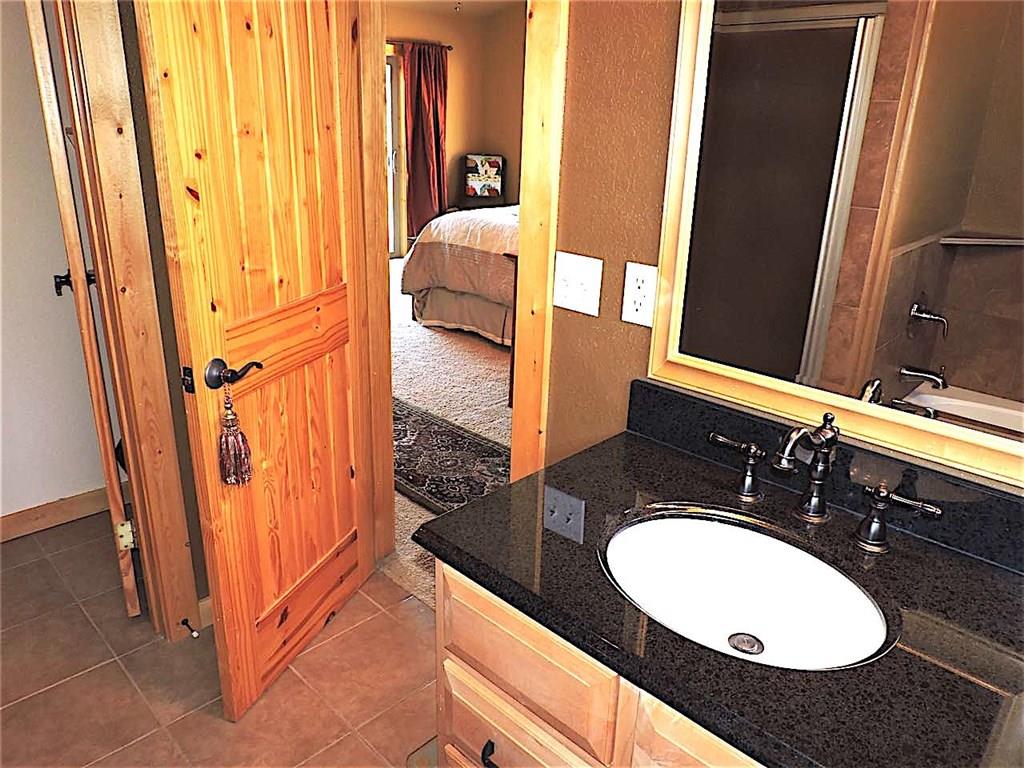 299 Gadwall Road Como, CO 80432 - Photo 14 of 25 a bathroom with a granite countertop sink and a mirror