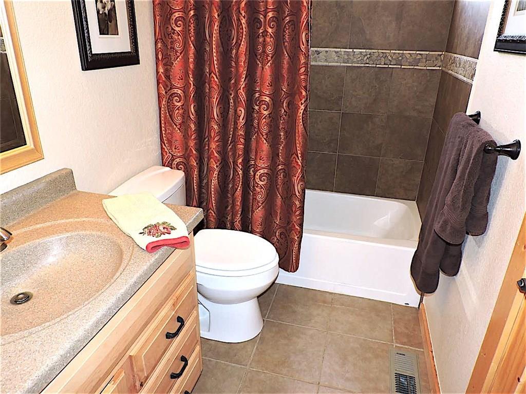 299 Gadwall Road Como, CO 80432 - Photo 16 of 25 a white toilet sitting next to a bath tub and a shower