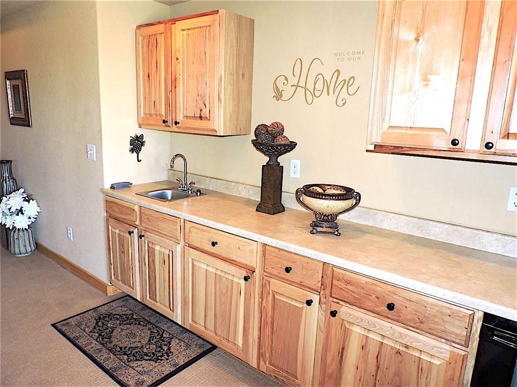 299 Gadwall Road Como, CO 80432 - Photo 19 of 25 a kitchen with stainless steel appliances a sink a stove and a window
