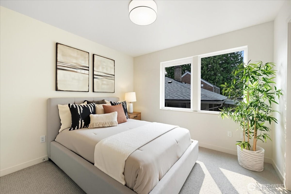 13047 39th Avenue Northeast, Unit B Seattle, WA 98125 - Photo 13 of 16 a bedroom with a large bed and a large window