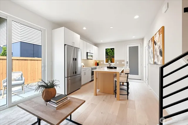 a kitchen with a table chairs refrigerator and microwave