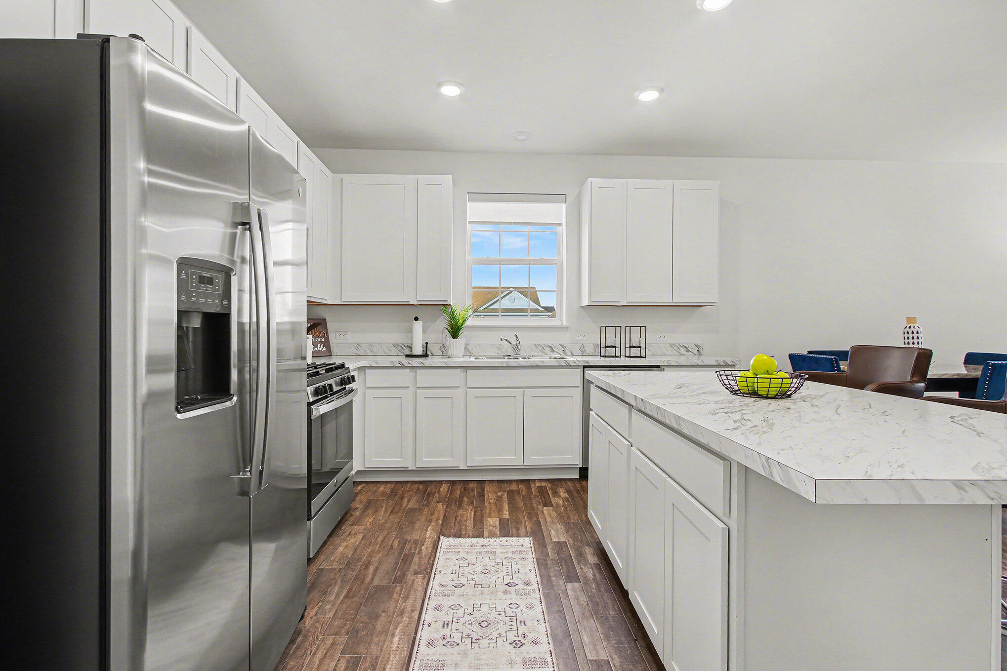 11649 Thomas Street Winfield, IN 46307 - Photo 2 of 15 a kitchen with a refrigerator sink and white cabinets