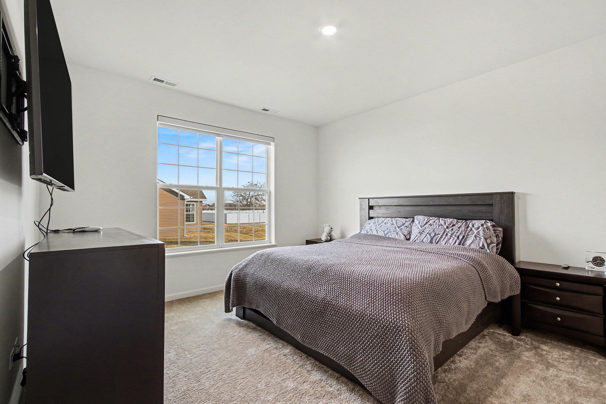 11649 Thomas Street Winfield, IN 46307 - Photo 8 of 15 a bedroom with a bed and a flat tv screen on dresser