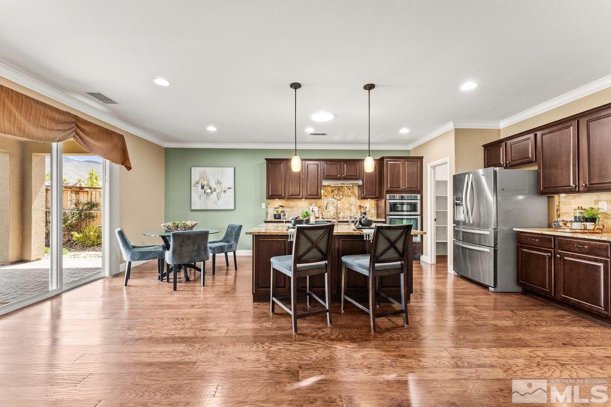 9860 Copenhagen Way Reno, NV 89521 - Photo 8 of 40 a view of a dining area with furniture window and wooden floor