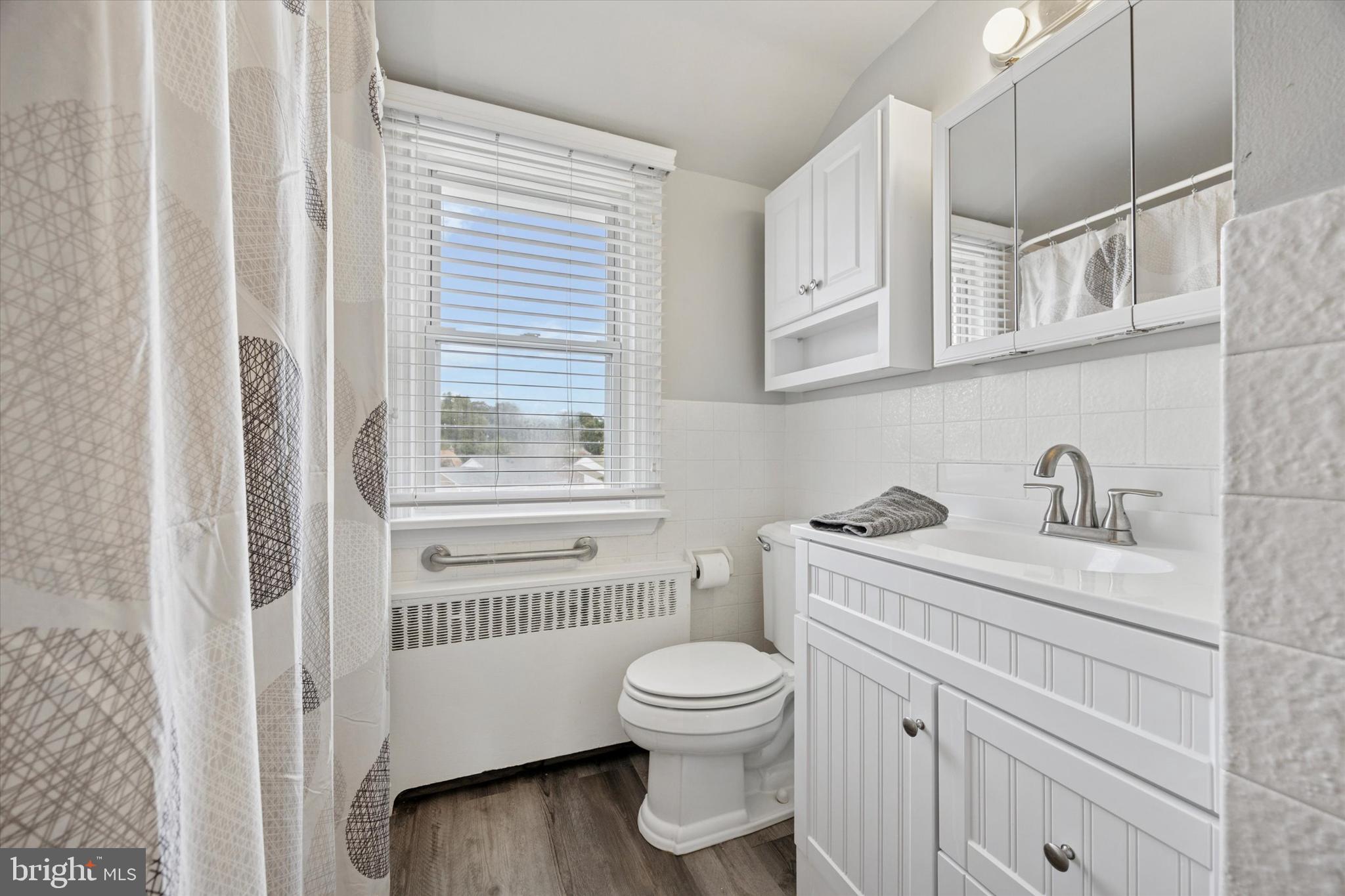 181 Friendship Road Drexel Hill, PA 19026 - Photo 22 of 24 a bathroom with a toilet a sink and a window