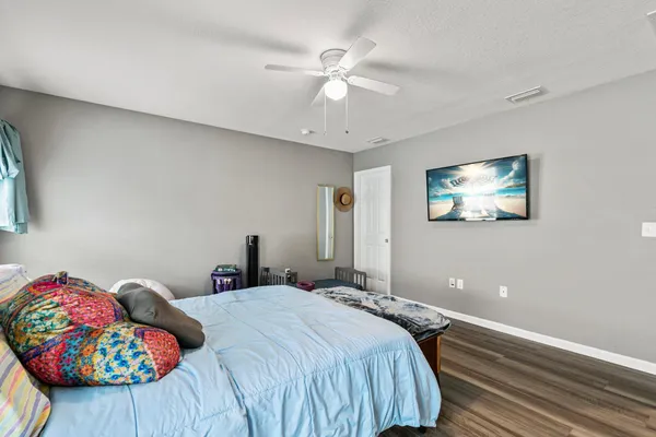 a bedroom with a bed and a chandelier