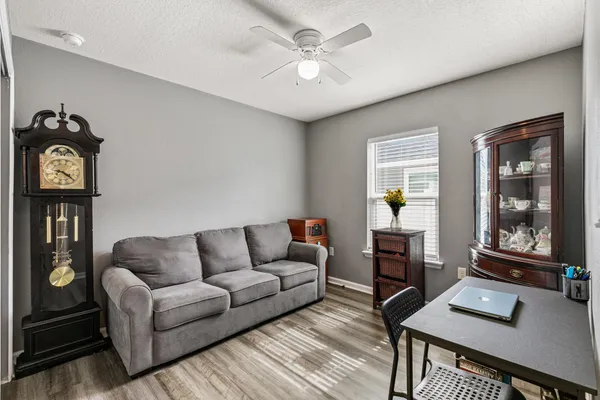 a living room with furniture a rug and a window