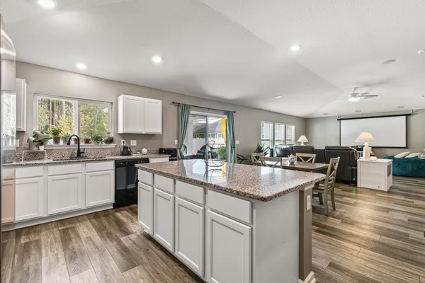 a kitchen with sink stove and cabinets