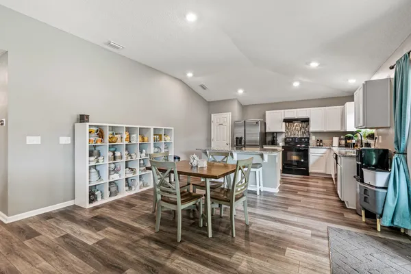 a view of a dining room with furniture and wooden floor