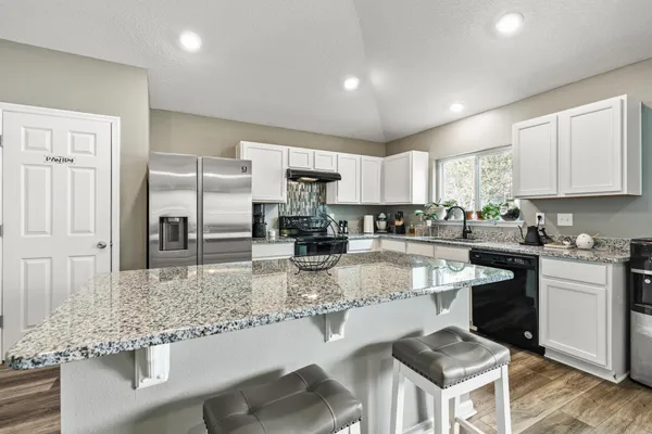 a kitchen with refrigerator and cabinets