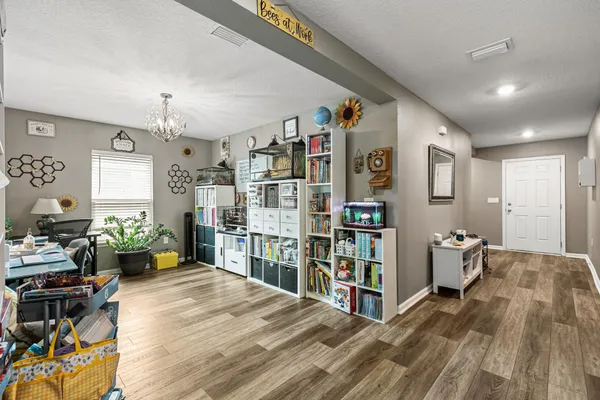 a living room with lots of furniture and book shelf