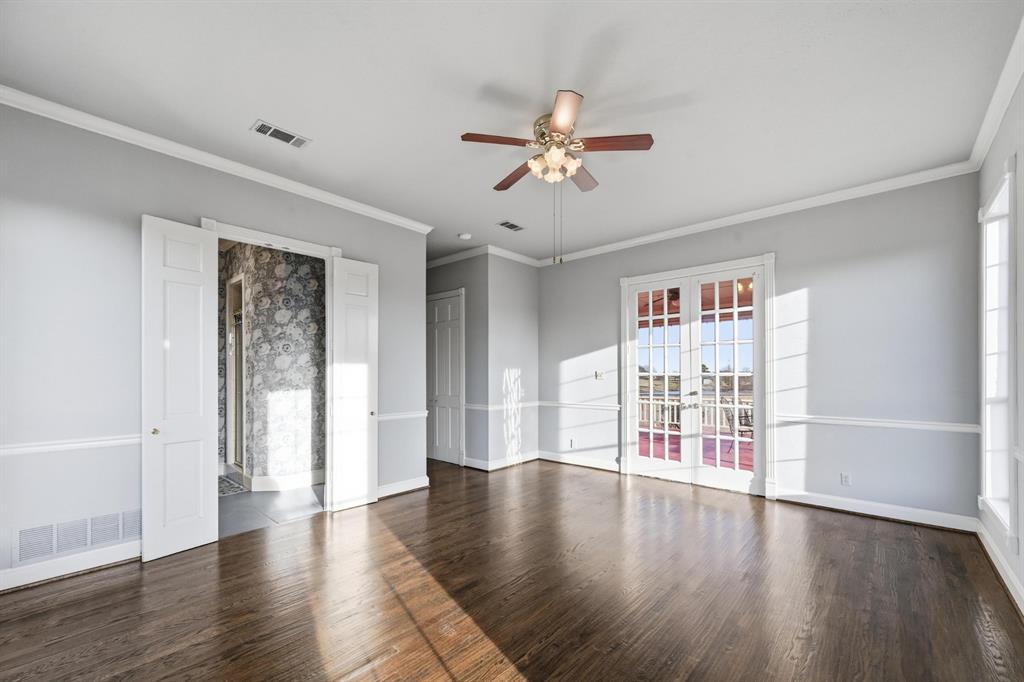 707 Cullins Road Rockwall, TX 75032 - Photo 19 of 40 a view of an empty room with a window and wooden floor
