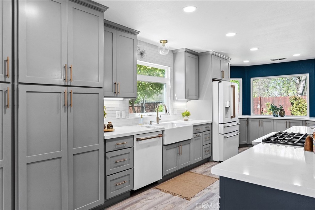 2 Baroni Drive Chico, CA 95928 - Photo 14 of 63 a kitchen with white cabinets and white appliances