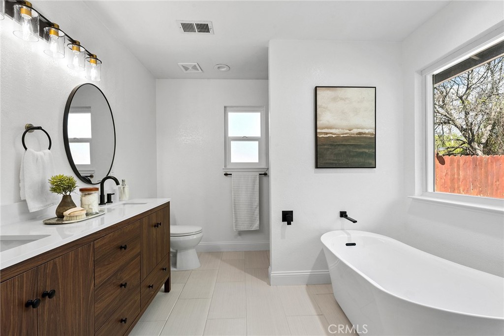 2 Baroni Drive Chico, CA 95928 - Photo 28 of 63 a bathroom with a double vanity sink a toilet and bathtub