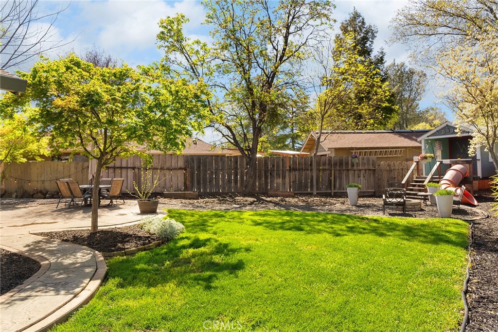 2 Baroni Drive Chico, CA 95928 - Photo 47 of 63 a view of a backyard with table and chairs and wooden fence