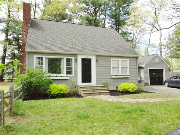 27 Birch Road Natick, MA 01760 - Photo 13 of 16 a front view of a house with a yard and garage