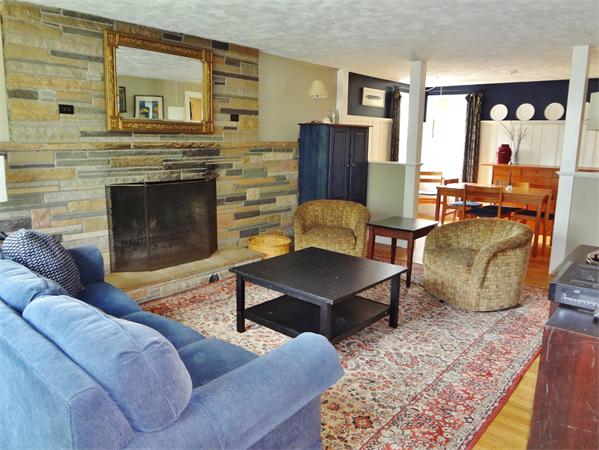 27 Birch Road Natick, MA 01760 - Photo 2 of 16 a living room with furniture wooden floor and a fireplace