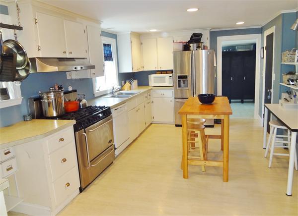 27 Birch Road Natick, MA 01760 - Photo 5 of 16 a kitchen with stainless steel appliances granite countertop a sink and a refrigerator