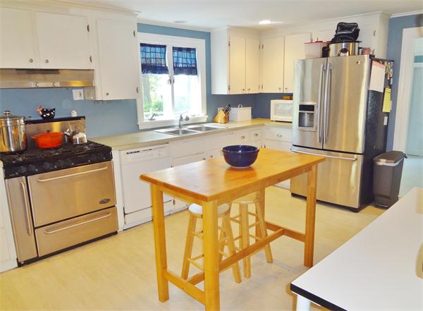 27 Birch Road Natick, MA 01760 - Photo 6 of 16 a kitchen with a sink a stove and a refrigerator