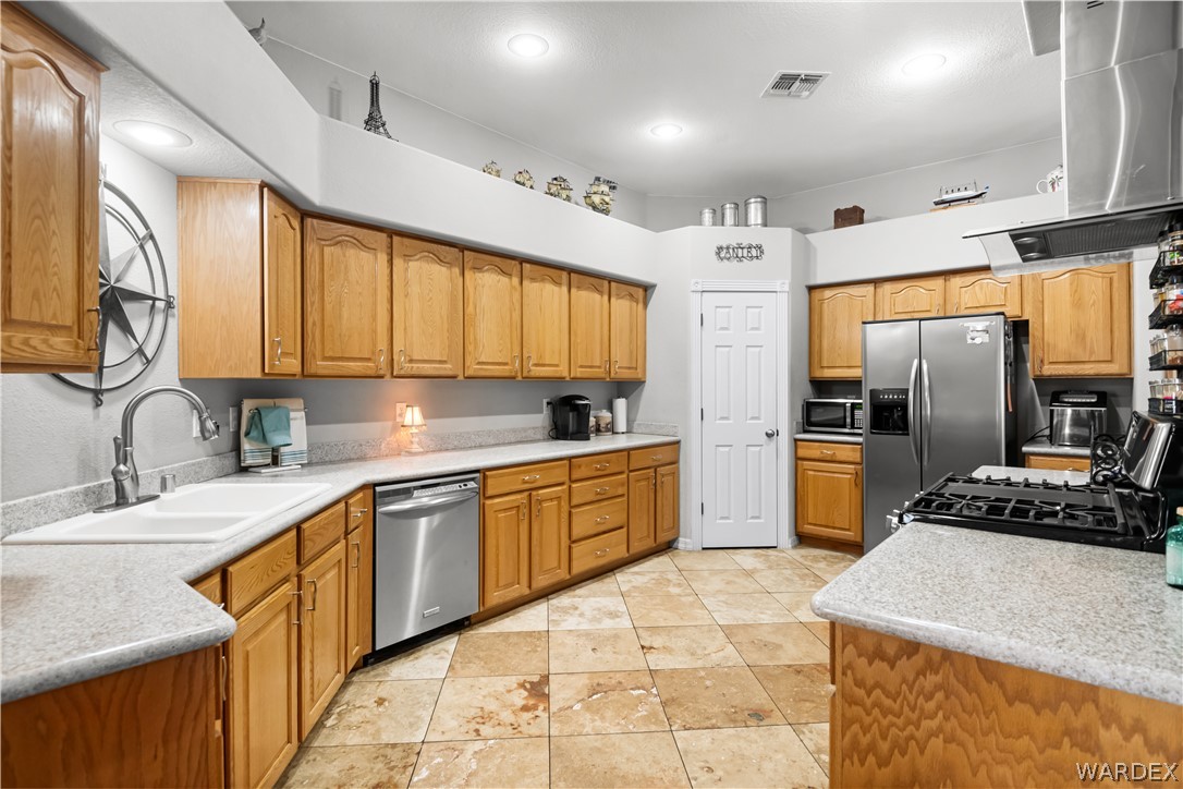 2898 Mountain Trail Road Kingman, AZ 86401 - Photo 9 of 75 a kitchen with stainless steel appliances granite countertop a sink stove and refrigerator