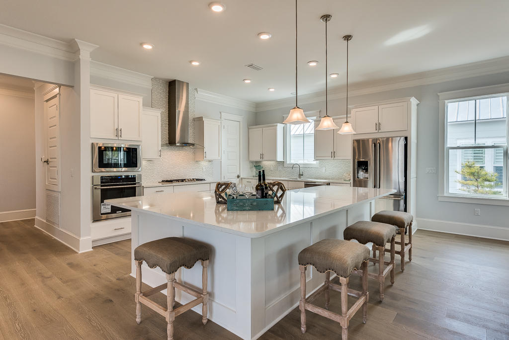 20 Prominence Square Inlet Beach Inlet Beach, FL 32461 - Photo 25 of 53 a kitchen with stainless steel appliances kitchen island granite countertop a stove a refrigerator a oven a sink with a dining table and chairs