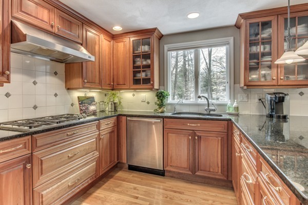 3 Wildwood Road Lexington, MA 02421 - Photo 3 of 19 a kitchen with granite countertop wooden cabinets stainless steel appliances a sink and a large window