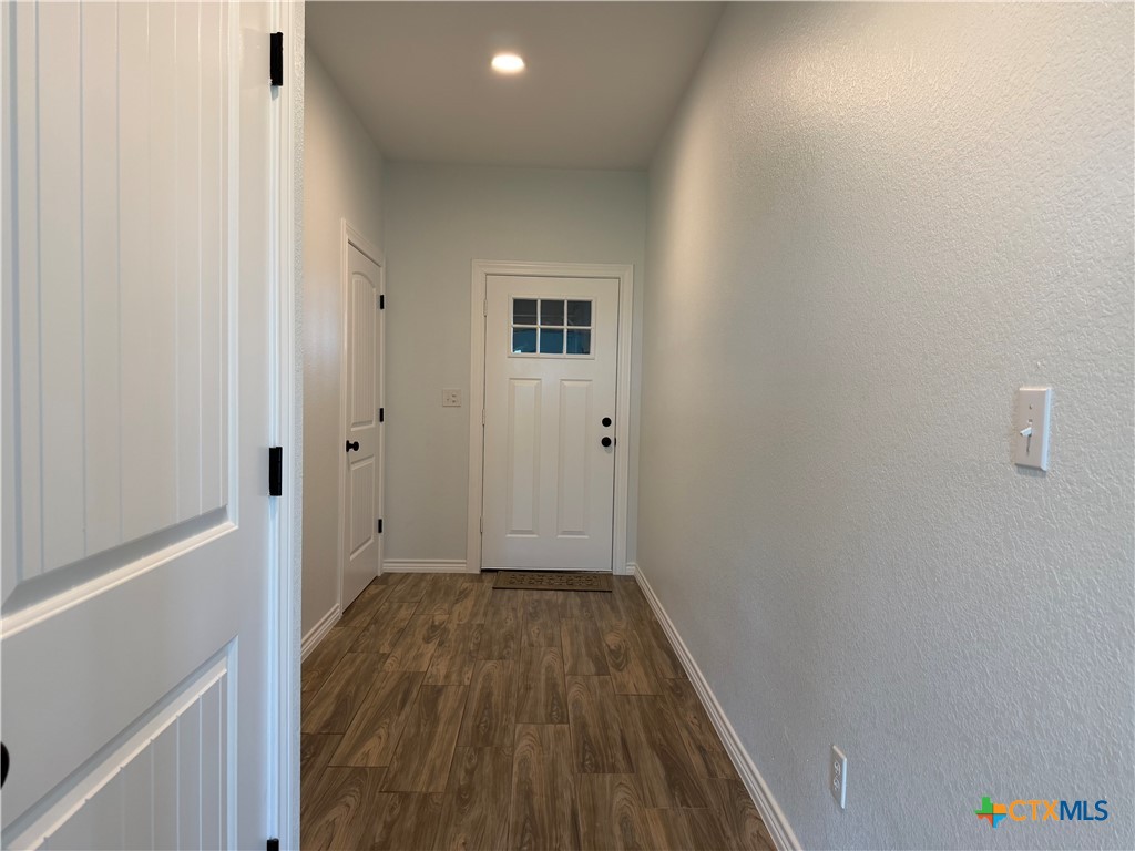 15006 Armstrong Ests Road Salado, TX 76571 - Photo 18 of 29 a view of a hallway with wooden floor