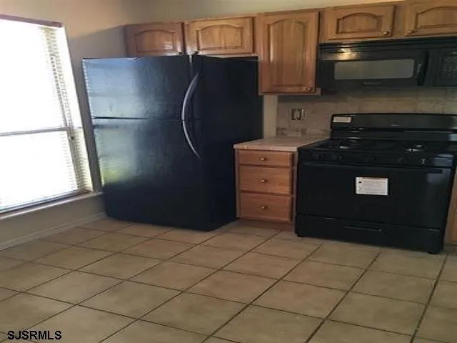 a kitchen with a refrigerator and a stove