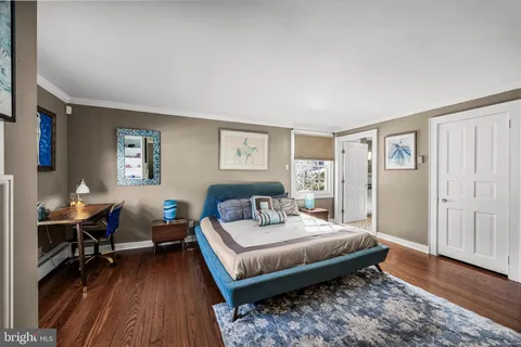 a bedroom with bed and a chandelier