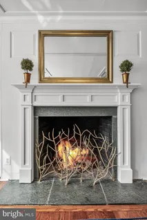a living room with furniture couches and a dining table with garden view