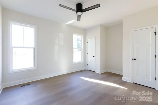 a view of a room with a window and a ceiling fan