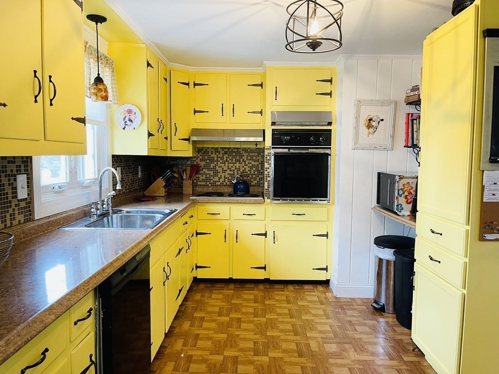 61 Fenner Street Fall River, MA 02724 - Photo 11 of 23 a kitchen with stainless steel appliances a stove a sink and a refrigerator
