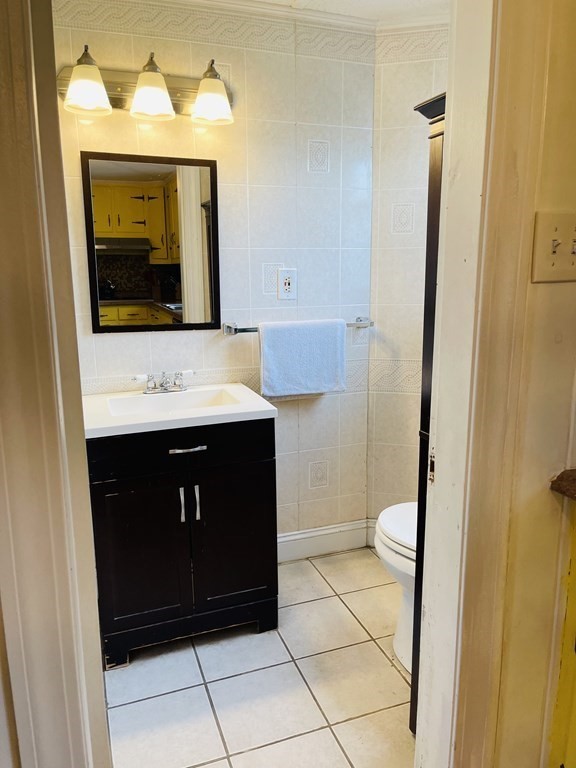 61 Fenner Street Fall River, MA 02724 - Photo 12 of 23 a bathroom with a toilet a sink and mirror