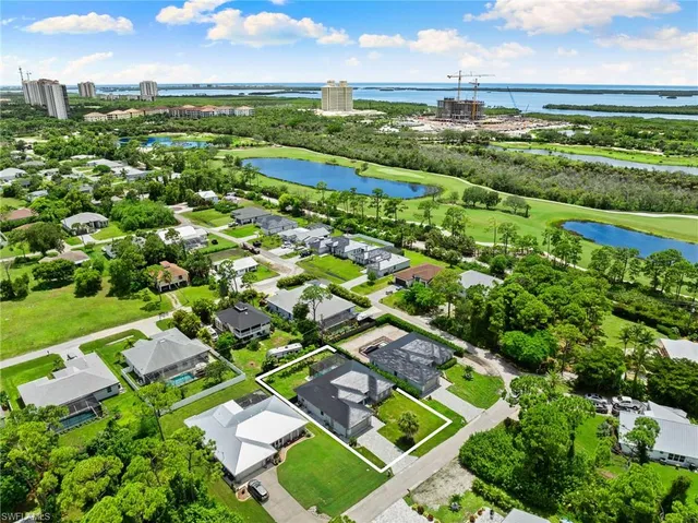 an aerial view of residential houses with outdoor space and street view