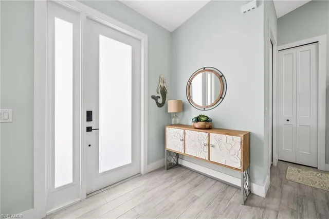 a view of an entryway with wooden floor