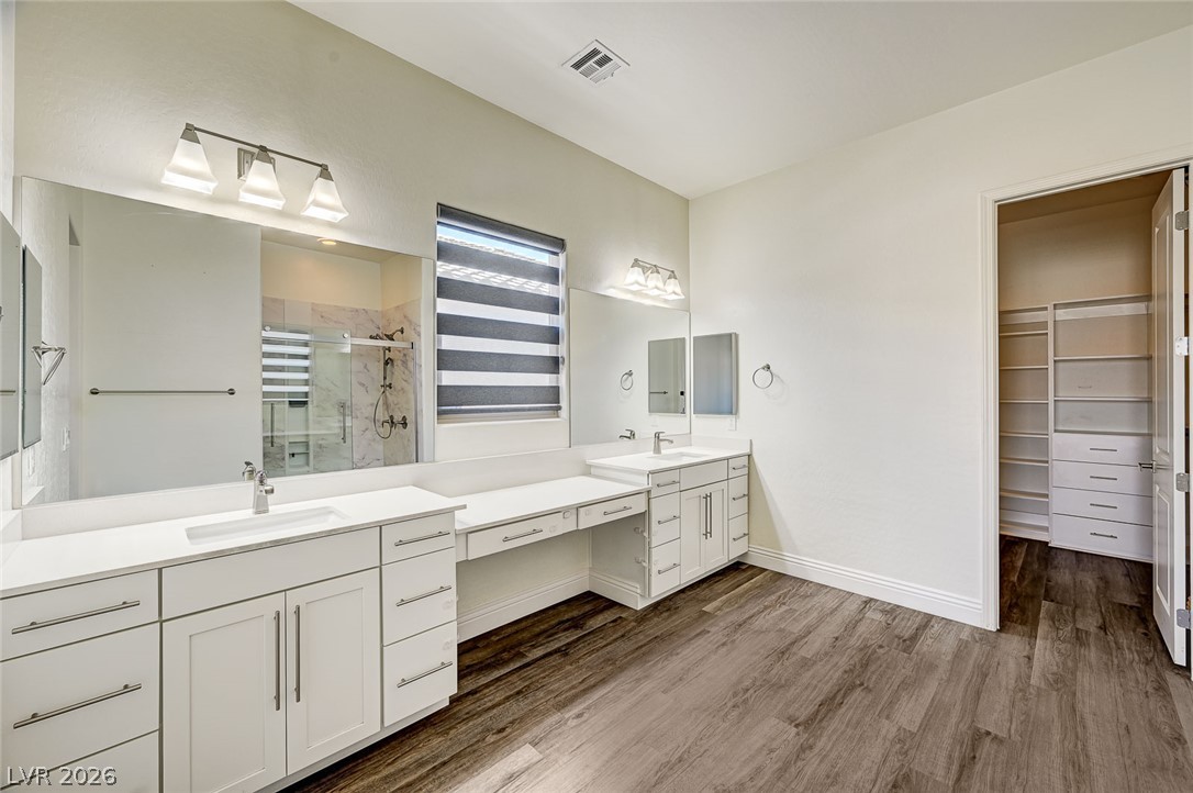 8197 Riley Love Street Las Vegas, NV 89139 - Photo 30 of 48 Ample counter space and dual vanities define this naturally illuminated primary bathroom, perfect for unwinding.