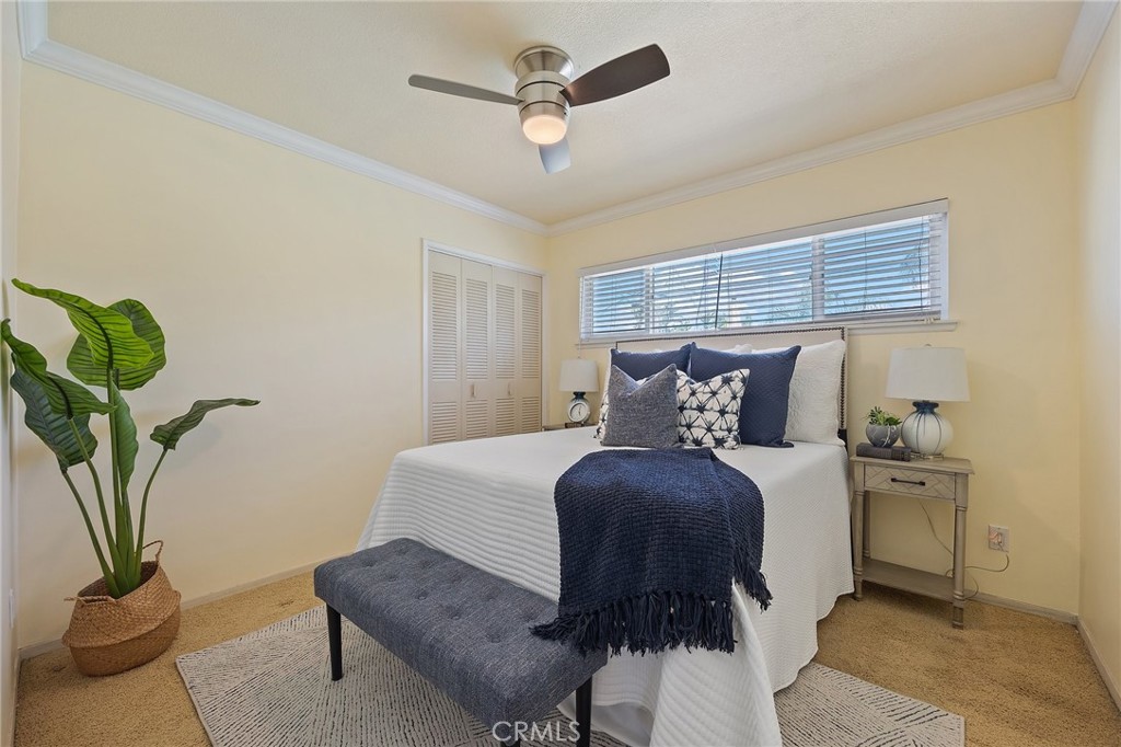 14895 Fairvilla Drive La Mirada, CA 90638 - Photo 15 of 31 a bedroom with bed and a chandelier