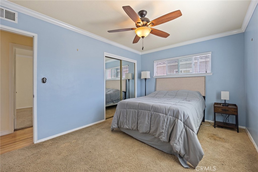 14895 Fairvilla Drive La Mirada, CA 90638 - Photo 17 of 31 a bedroom with a bed and a chandelier