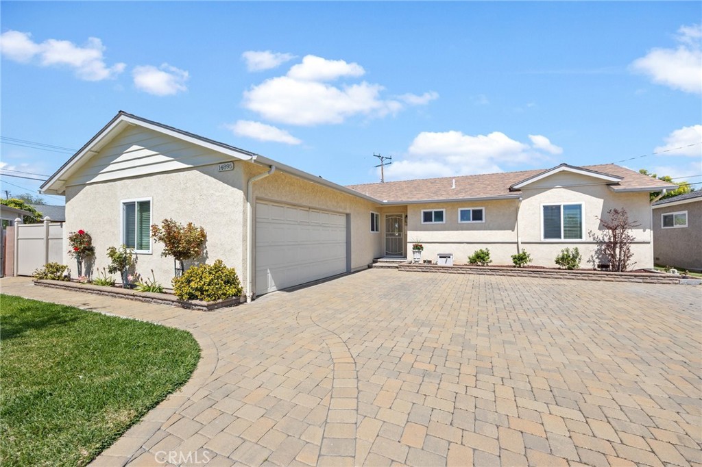 14895 Fairvilla Drive La Mirada, CA 90638 - Photo 2 of 31 a front view of a house with a yard and garage