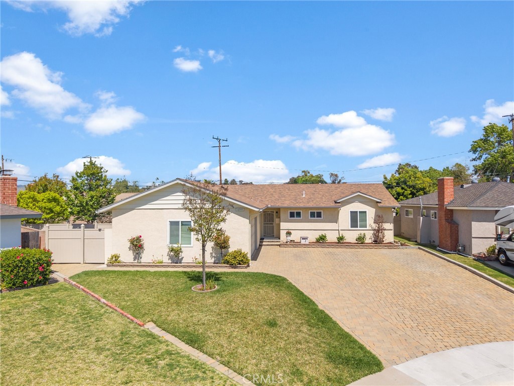 14895 Fairvilla Drive La Mirada, CA 90638 - Photo 3 of 31 a view of a white house next to a yard with potted plants