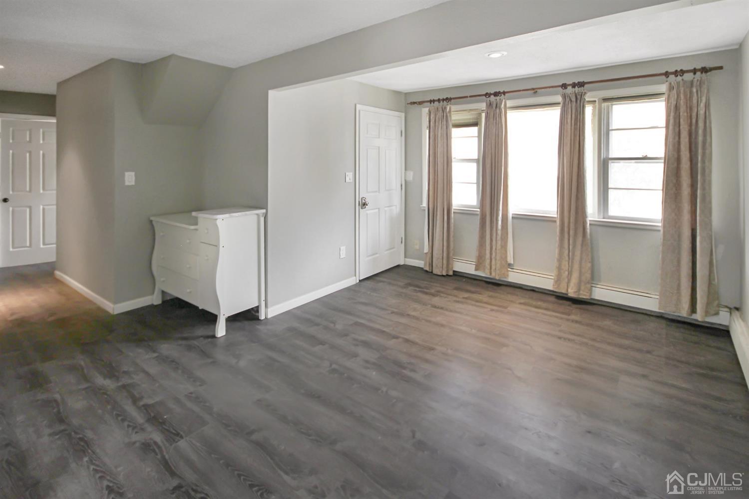 3 Dobson Road Edison, NJ 08817 - Photo 3 of 25 an empty room with wooden floor and windows