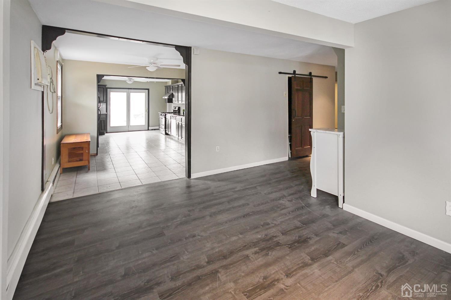 3 Dobson Road Edison, NJ 08817 - Photo 5 of 25 a view of a hallway with wooden floor and a living room