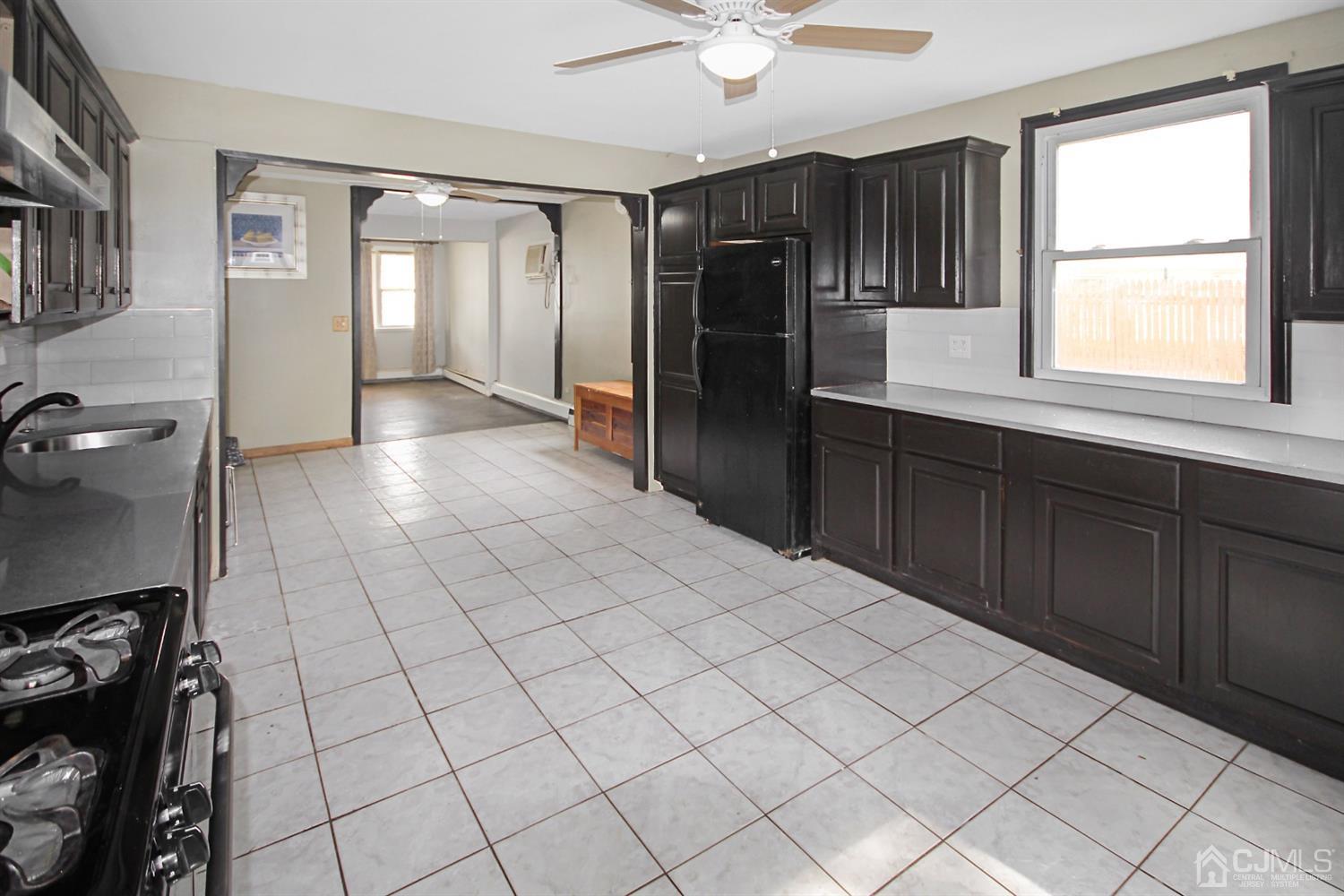 3 Dobson Road Edison, NJ 08817 - Photo 8 of 25 a large white kitchen with granite countertop a sink and a refrigerator