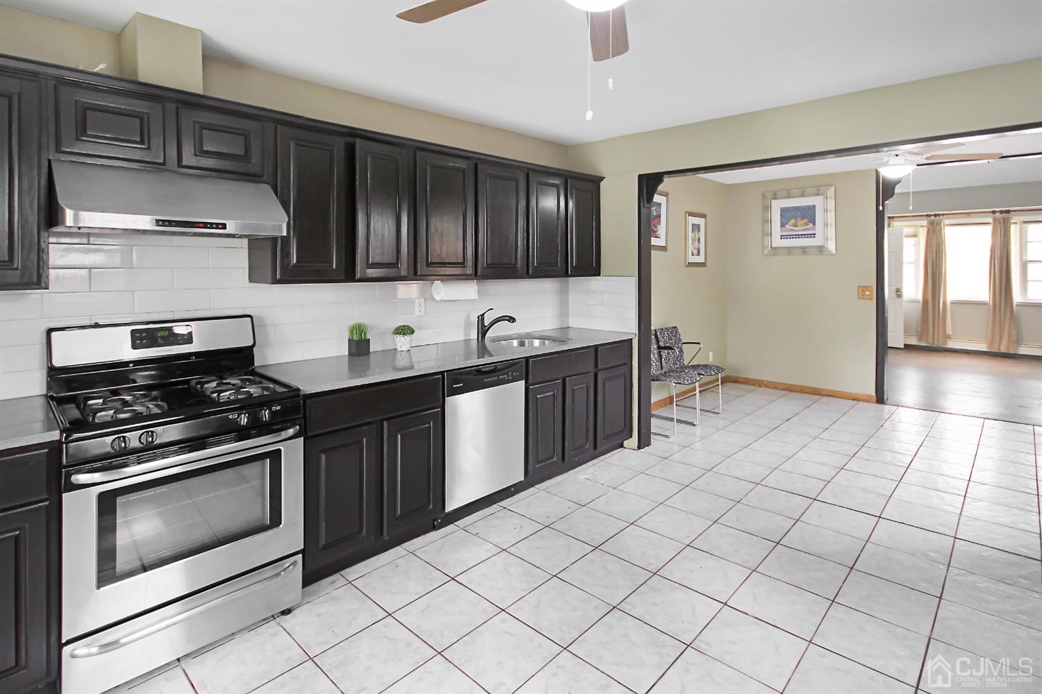 3 Dobson Road Edison, NJ 08817 - Photo 9 of 25 a kitchen with stainless steel appliances a stove sink and cabinets