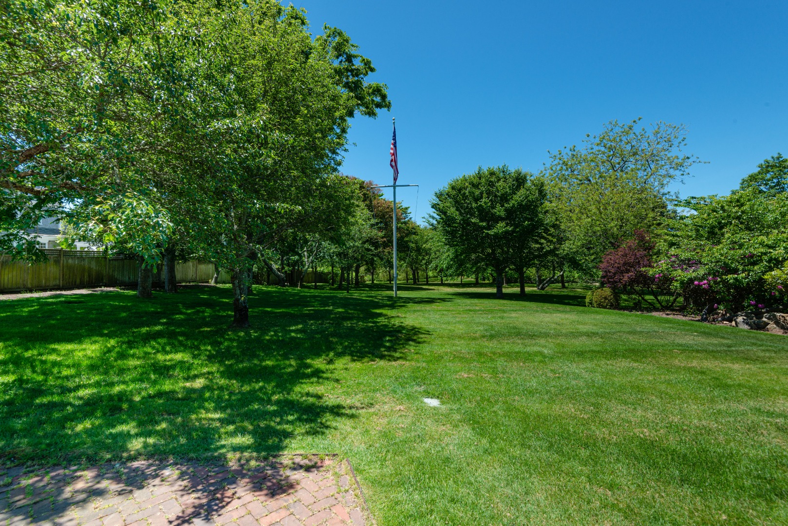 24 Cliff Road Nantucket, MA 02554 - Photo 13 of 44 a view of a grassy field with trees