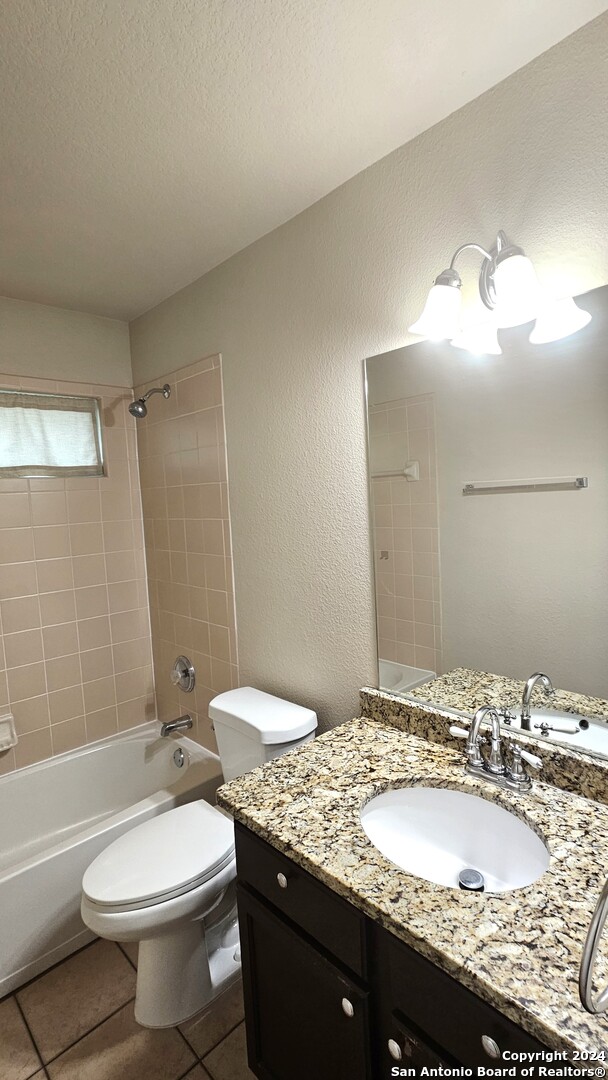 209 Storm Mt Road Cibolo, TX 78108 - Photo 15 of 28 a bathroom with a granite countertop sink toilet and shower