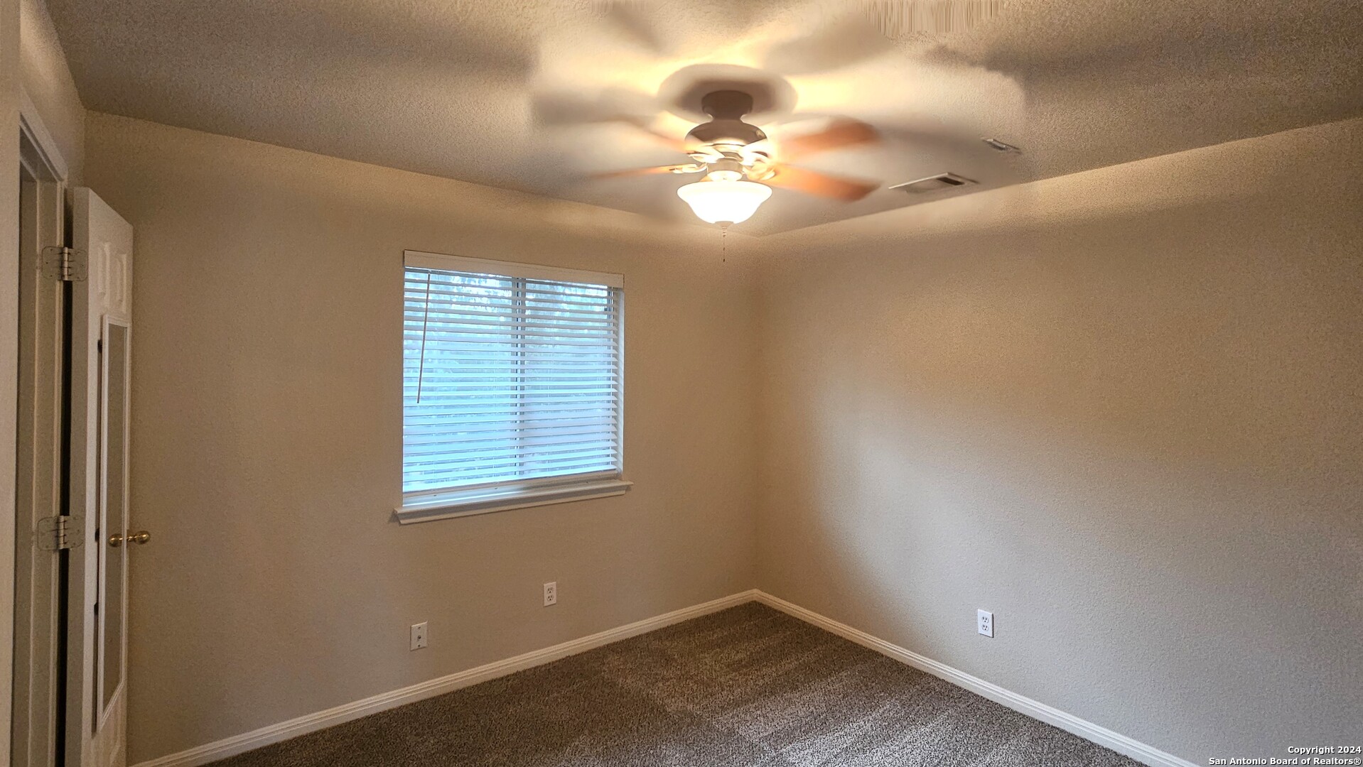 209 Storm Mt Road Cibolo, TX 78108 - Photo 23 of 28 a view of a room with windows and chandelier fan