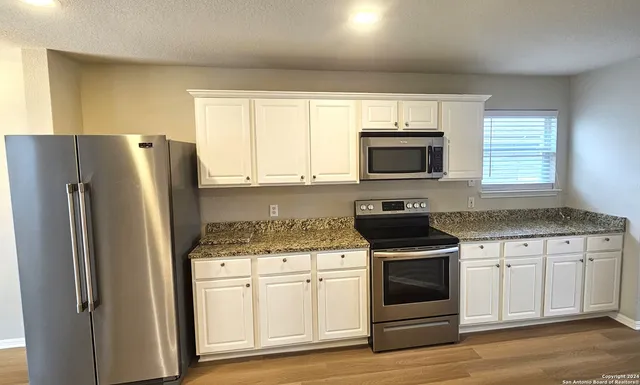 a kitchen with a stove microwave and refrigerator