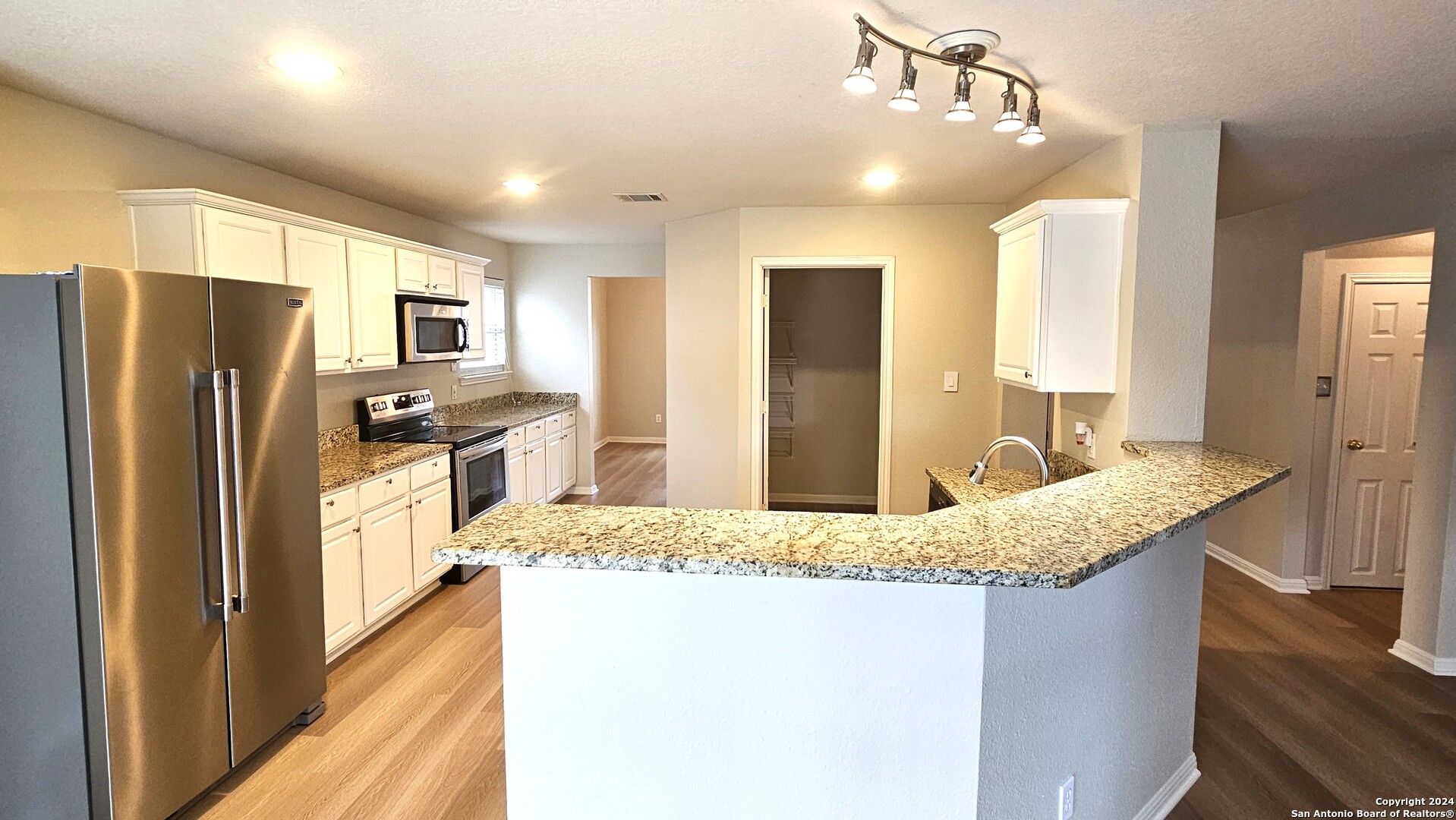 209 Storm Mt Road Cibolo, TX 78108 - Photo 5 of 28 a kitchen with stainless steel appliances granite countertop counter top a refrigerator a sink and dishwasher
